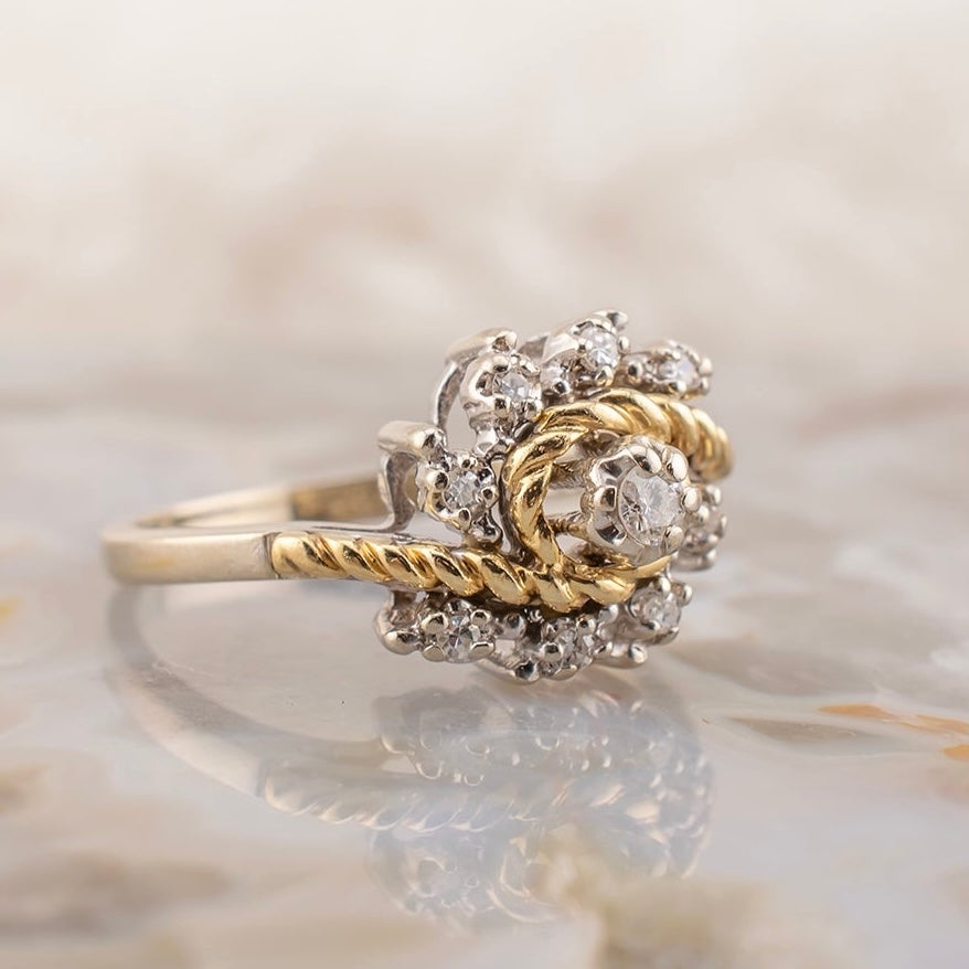 Vintage 14 Karat Two Tone White and Yellow Gold 0.12 Carat Diamond Swirl Design Ring With Rope Detail Size 5.75 Circa 1980s