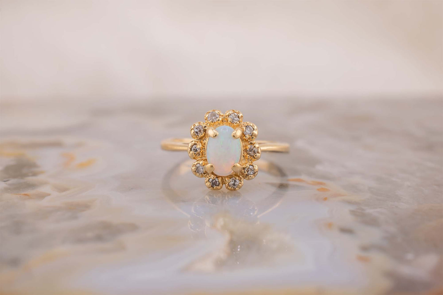 Circa 1940s Retro Era Vintage 14 Karat Yellow Gold 0.05 Carat Diamond Halo and 0.28 Carat Oval Cabochon Small Ring, Pinky Ring