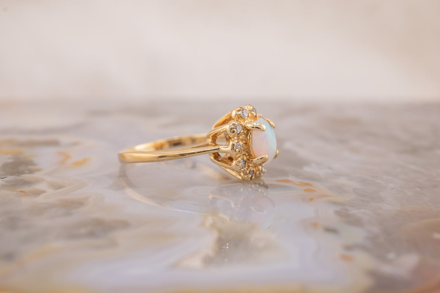 Circa 1940s Retro Era Vintage 14 Karat Yellow Gold 0.05 Carat Diamond Halo and 0.28 Carat Oval Cabochon Small Ring, Pinky Ring