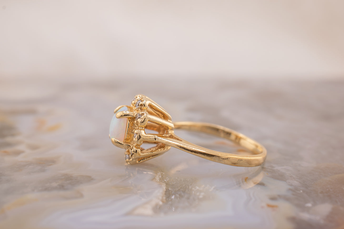 Circa 1940s Retro Era Vintage 14 Karat Yellow Gold 0.05 Carat Diamond Halo and 0.28 Carat Oval Cabochon Small Ring, Pinky Ring