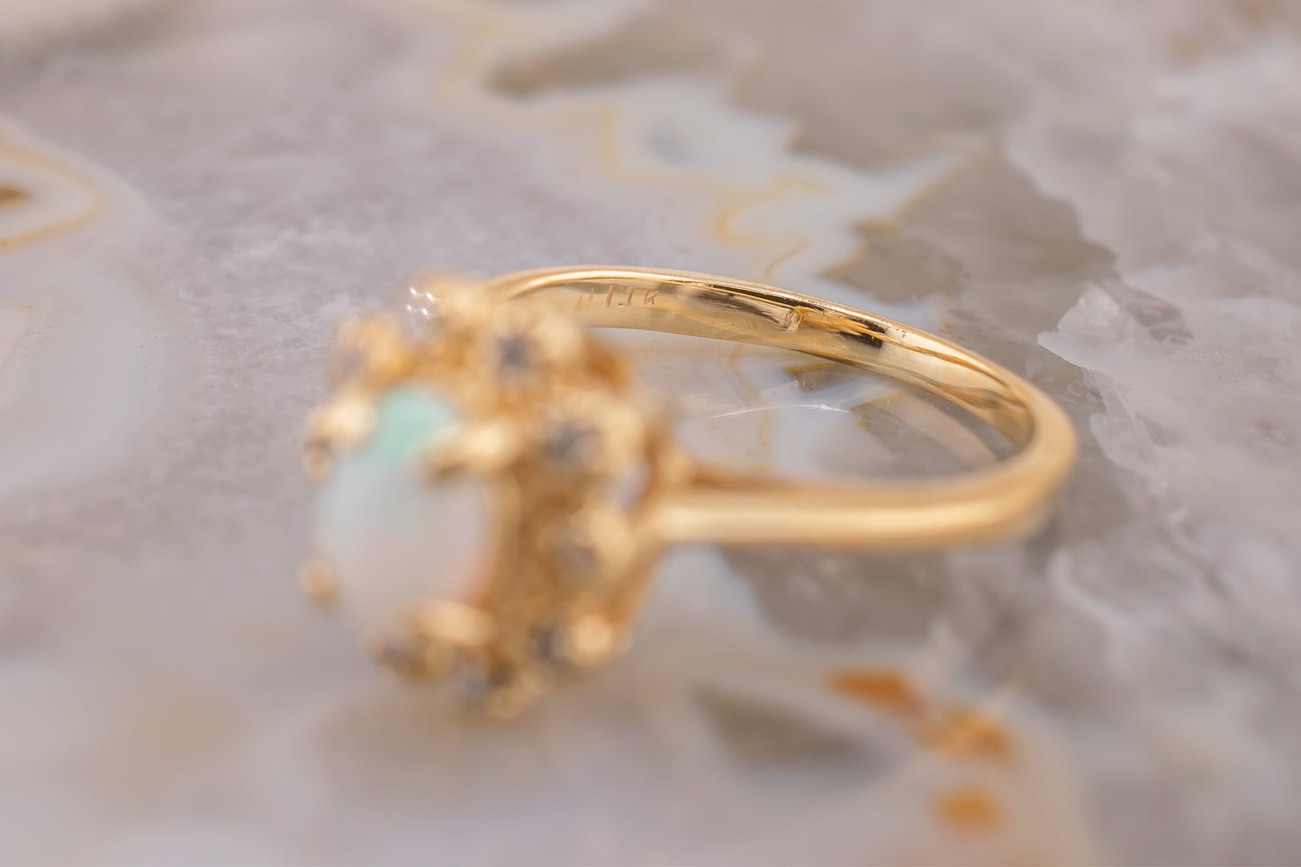 Circa 1940s Retro Era Vintage 14 Karat Yellow Gold 0.05 Carat Diamond Halo and 0.28 Carat Oval Cabochon Small Ring, Pinky Ring