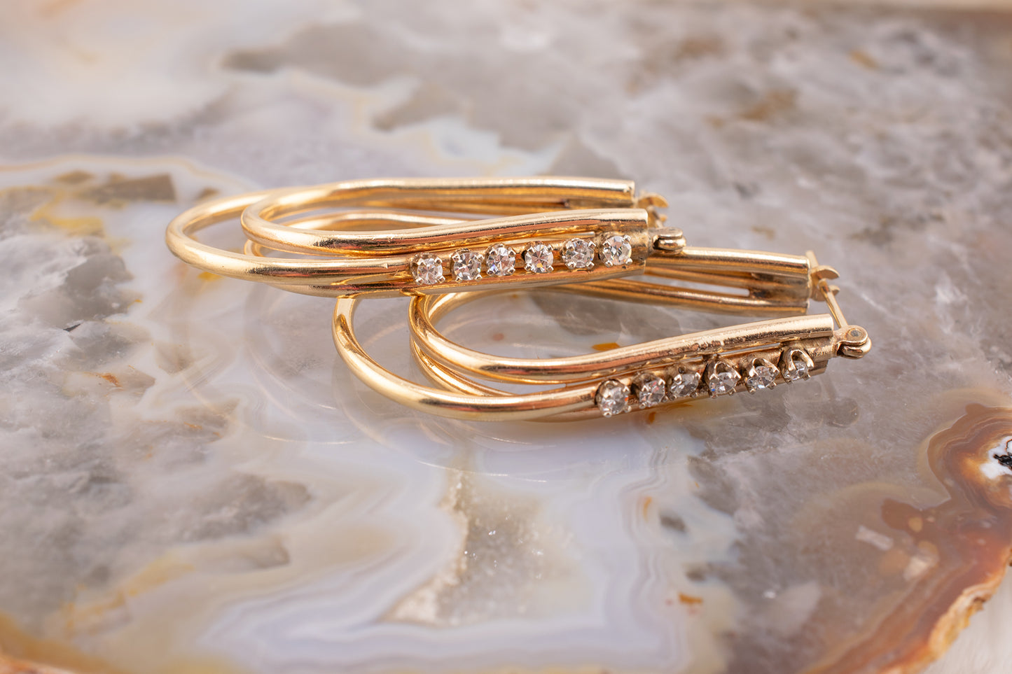 Circa 1980s Vintage 14 Karat Yellow Gold Prong Set 0.24 Carat Total Weight Natural Diamond Elongated Hoop Earrings 1.3 Inch Drop