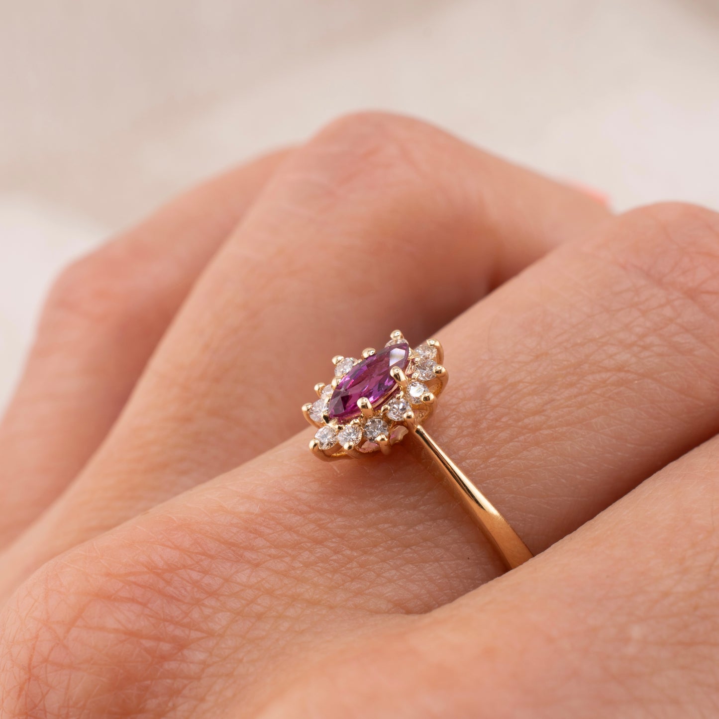 Vintage 14 Karat Yellow Gold 0.26 Carat Marquise Shape Pink Sapphire and 0.11 ctw. Diamond Halo Ring