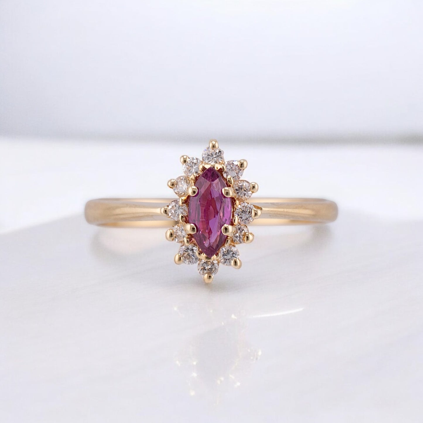 Vintage 14 Karat Yellow Gold 0.26 Carat Marquise Shape Pink Sapphire and 0.11 ctw. Diamond Halo Ring