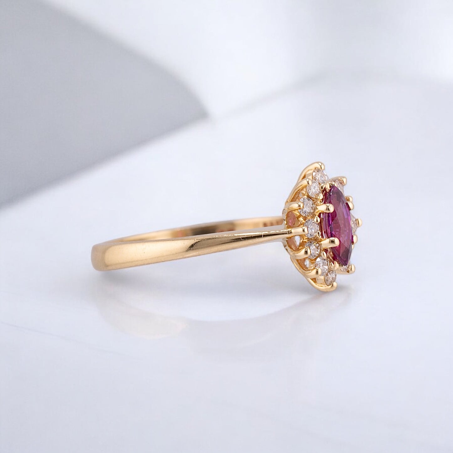 Vintage 14 Karat Yellow Gold 0.26 Carat Marquise Shape Pink Sapphire and 0.11 ctw. Diamond Halo Ring