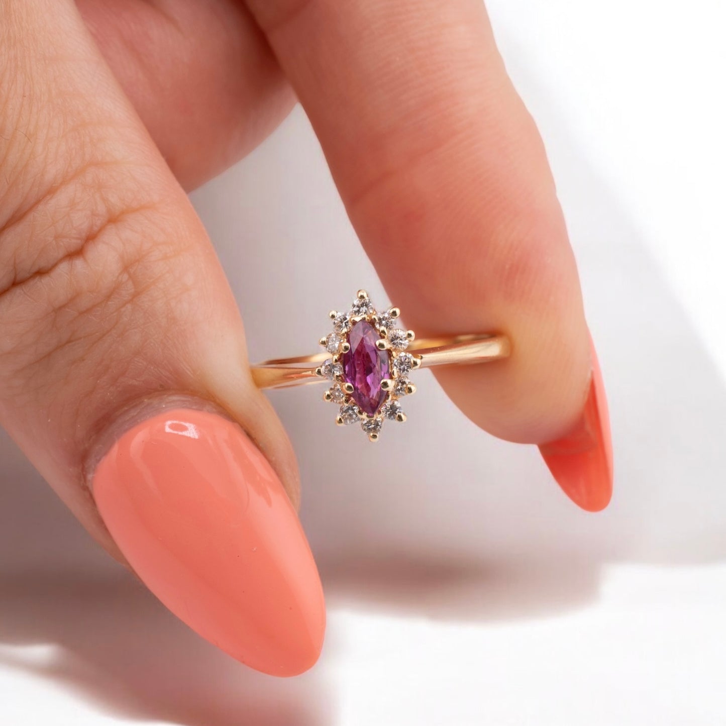 Vintage 14 Karat Yellow Gold 0.26 Carat Marquise Shape Pink Sapphire and 0.11 ctw. Diamond Halo Ring