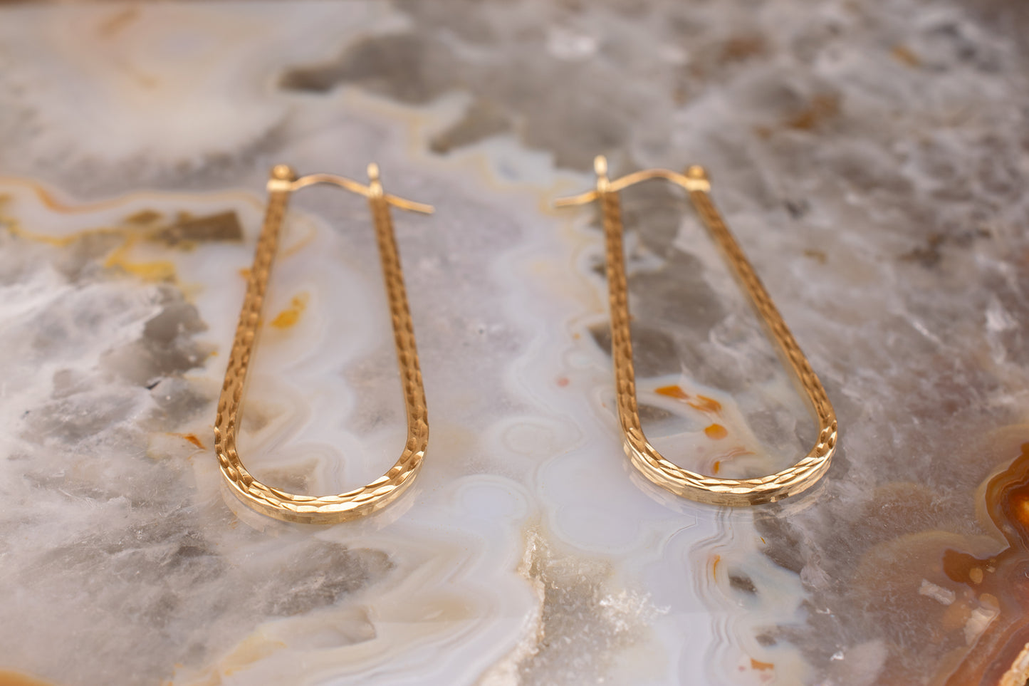 Circa 1990s Vintage 10 Karat Yellow Gold Elongated Diamond Cut Hoop Earrings