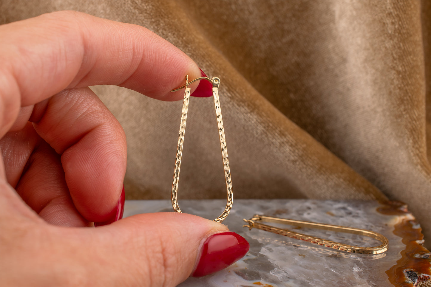 Circa 1990s Vintage 10 Karat Yellow Gold Elongated Diamond Cut Hoop Earrings