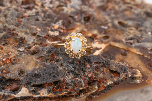 Circa 1940s Retro Era Vintage 14 Karat Yellow Gold 0.05 Carat Diamond Halo and 0.28 Carat Oval Cabochon Small Ring, Pinky Ring