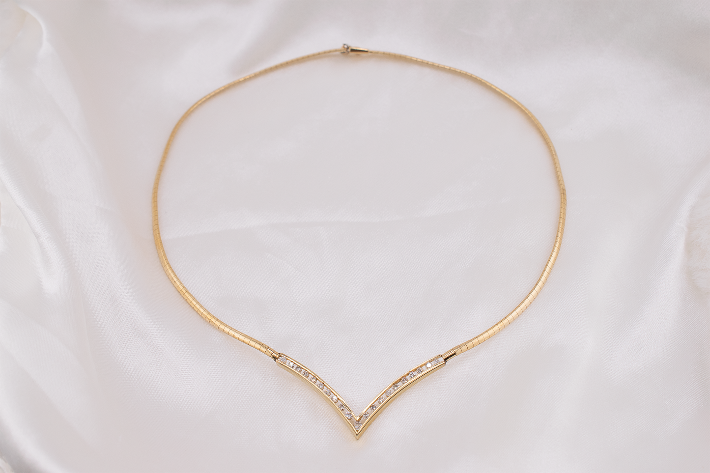 Circa 1980s Vintage 14 Karat Yellow Gold V-shape Channel Set Natural Diamond Necklace 0.97 Carats, Omega Chain, 17 Inches